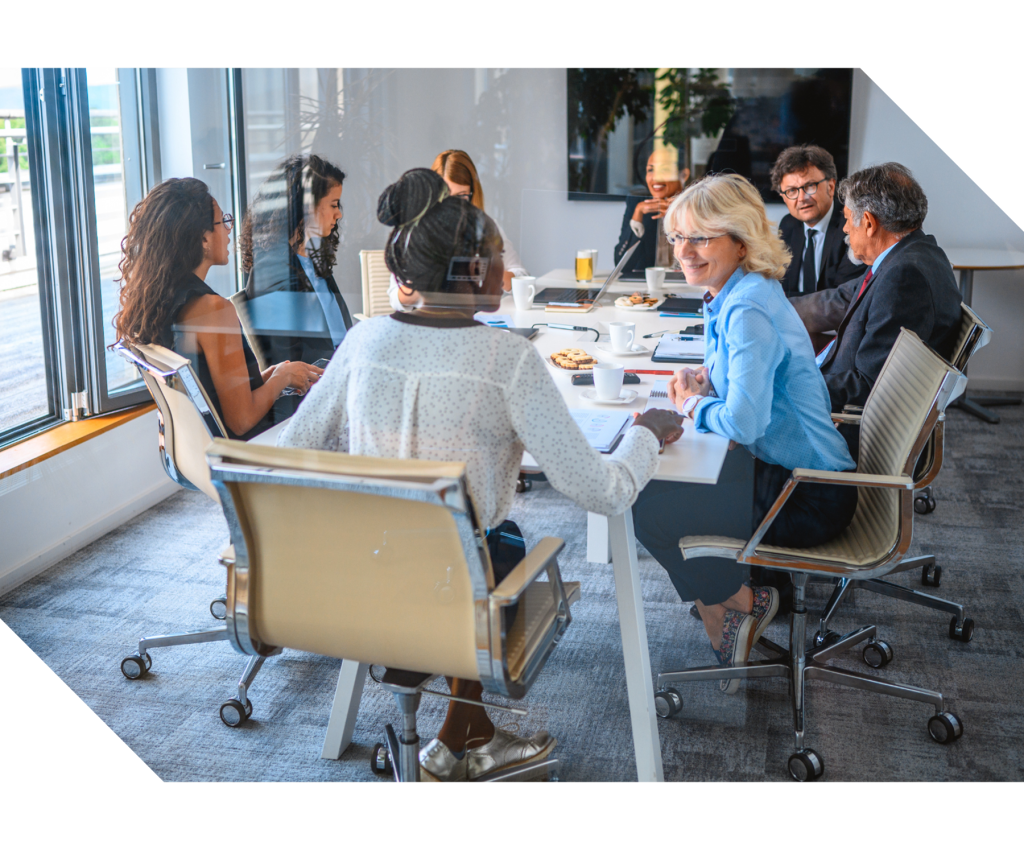 Group of professionals seated around a table in discussion, representing association management, governance support, collaboration, and organizational planning services.