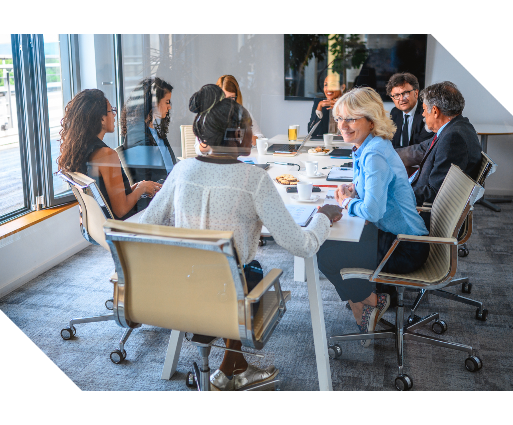 Group of professionals seated around a table in discussion, representing association management, governance support, collaboration, and organizational planning services.