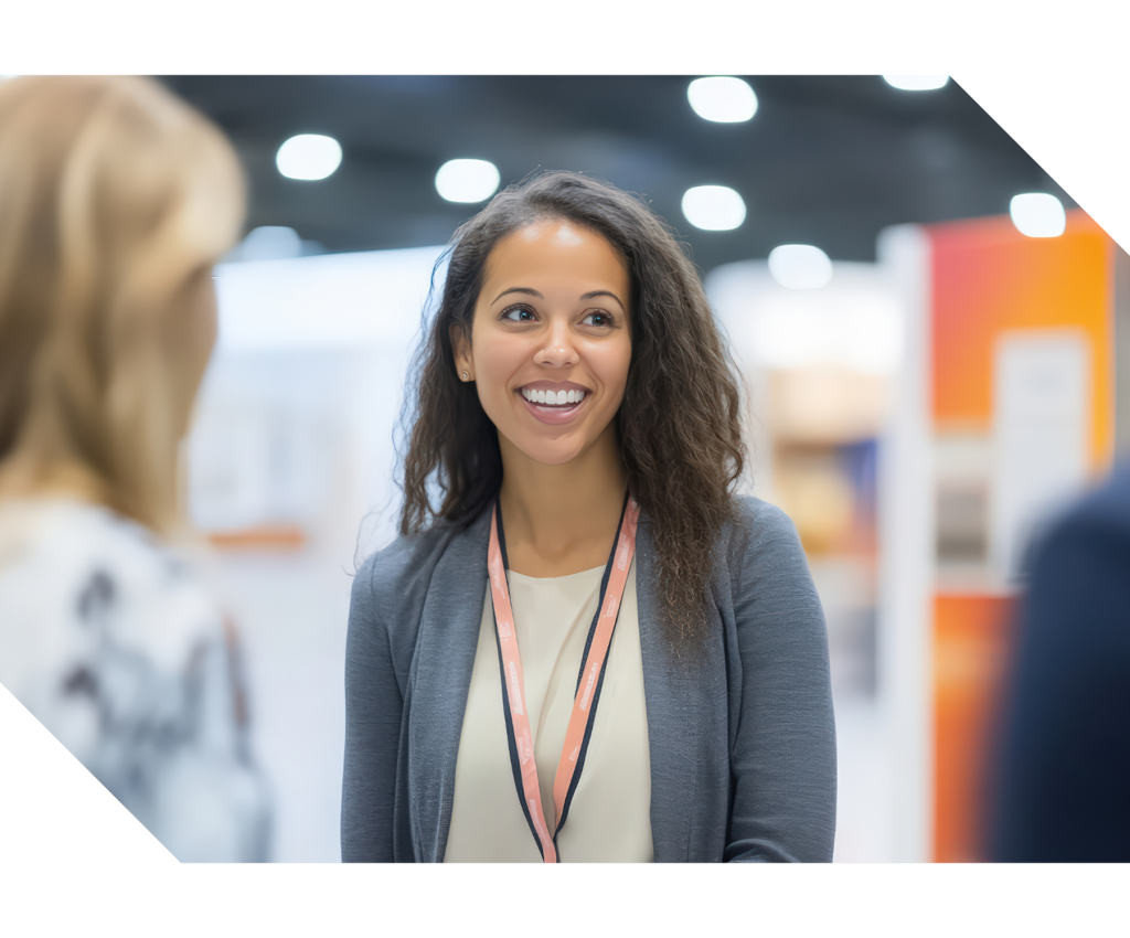 Attendees walking through a trade show floor with exhibitor booths and displays, representing trade shows, exhibitions, networking, and event management services.