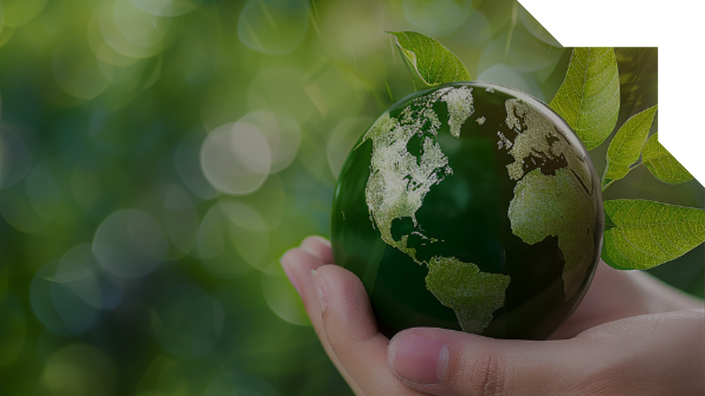 A hand holding a green, eco-friendly, Earth
