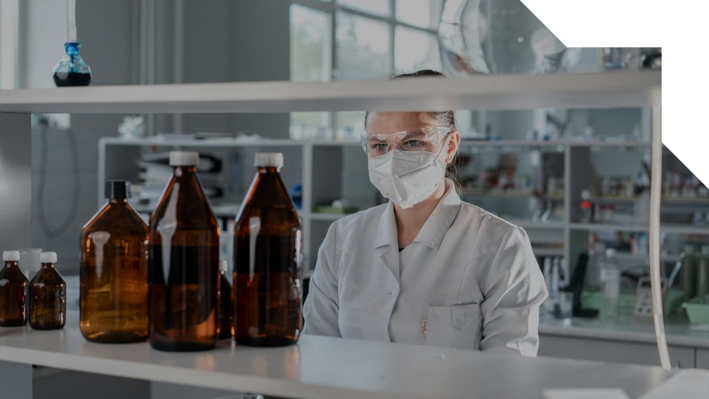 A scientist measuring bottles